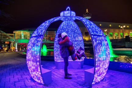couple enjoying a winter festival of lights display